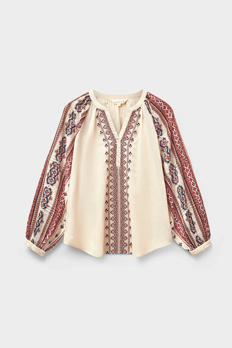 Beige blouse with red and brown embroidery on a white background