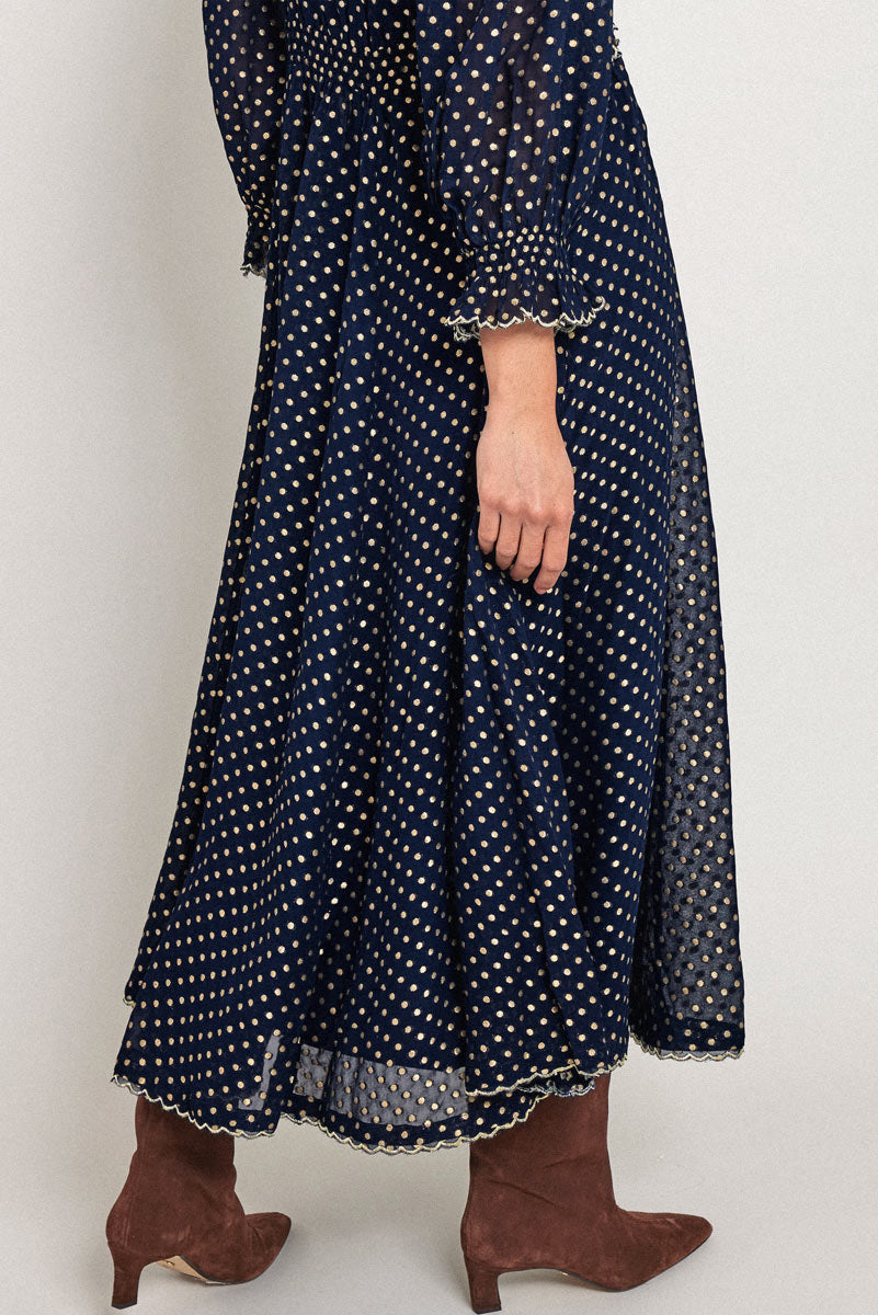 Model wears East Heritage Polina Gold Spot Dress.