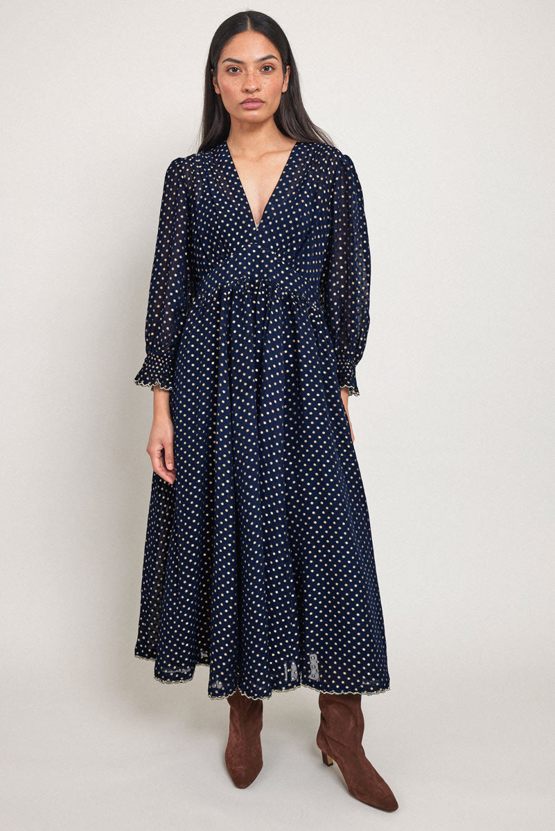 Model wears East Heritage Polina Gold Spot Dress.